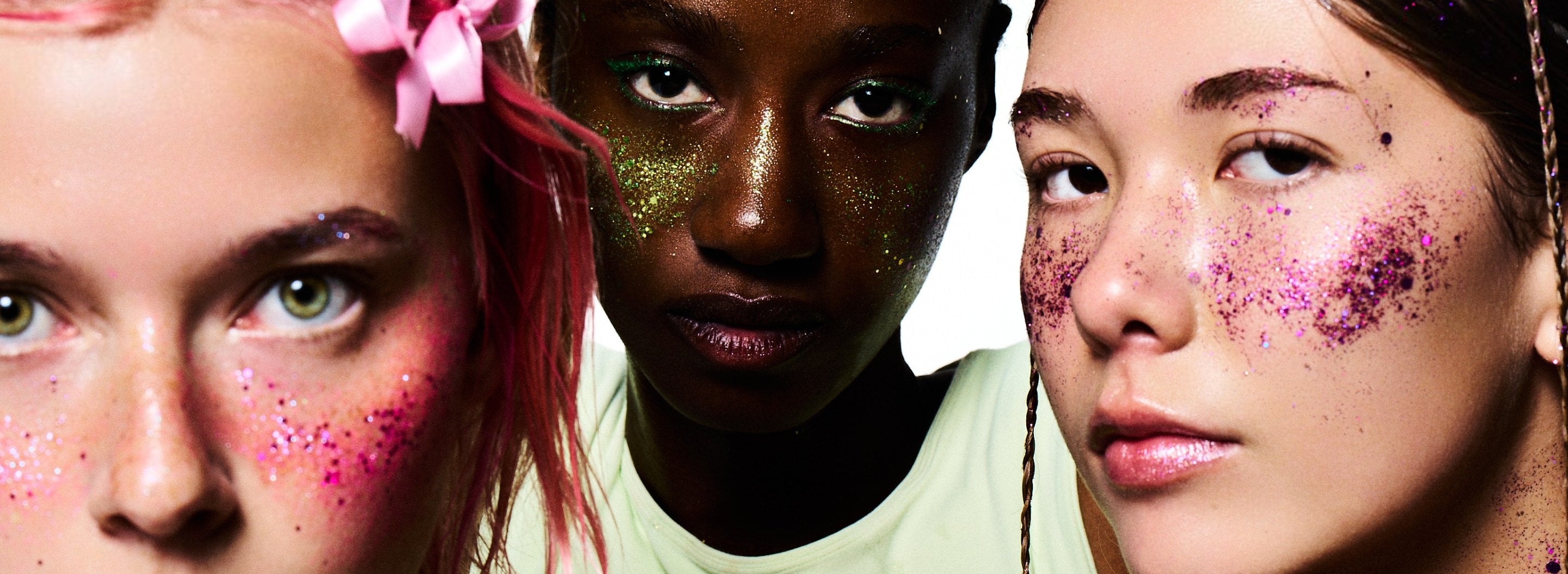 Three faces wearing GLOP glitter